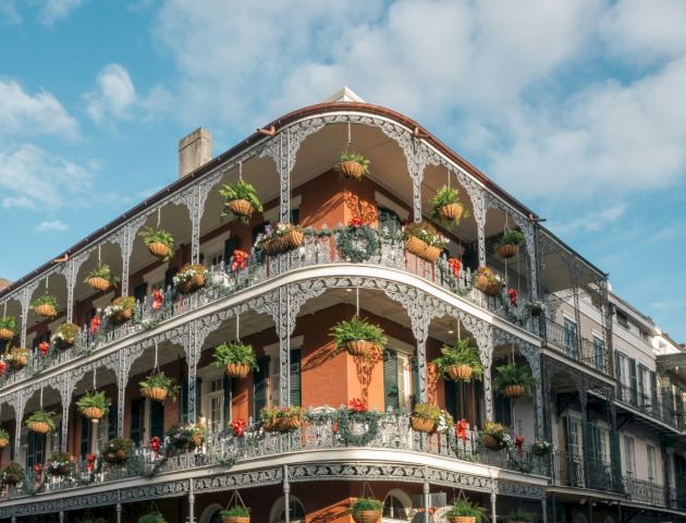 A multi-story building with ornate balconies and potted plants